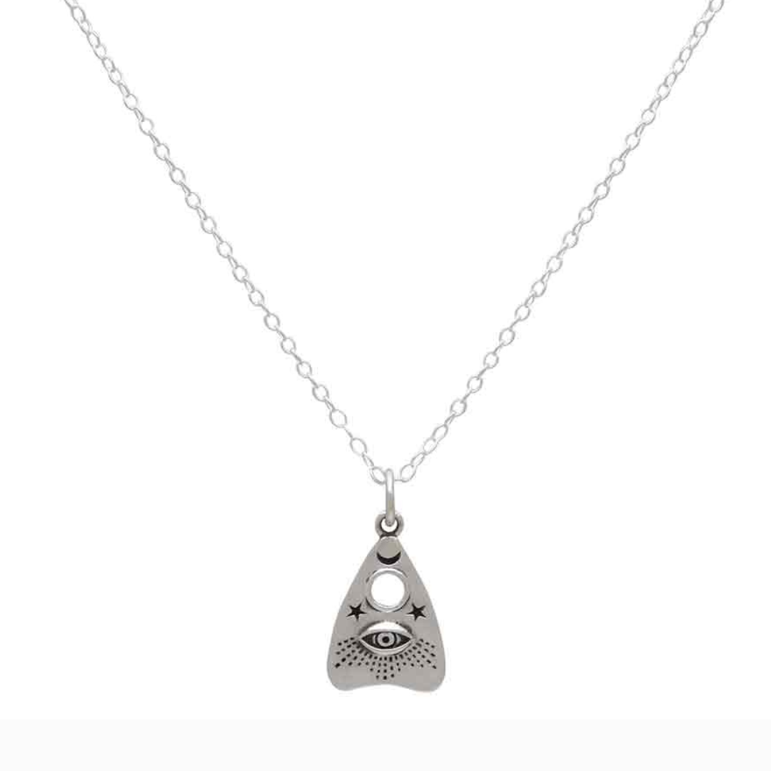 Oracle Necklace in sterling silver with eye, moon, and star symbols.