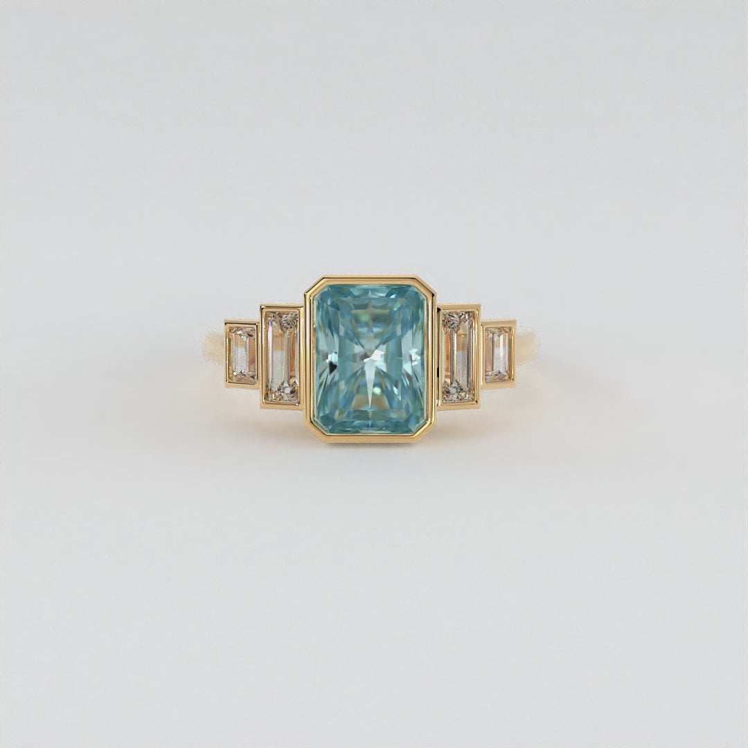 Lustre Ring in 14k yellow gold featuring a radiant cut gemstone and baguette accents, bezel set in a sleek and polished design